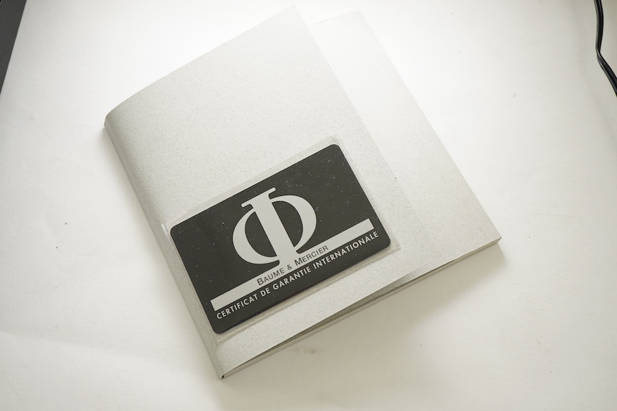 A lady's late 1990's stainless steel Baume & Mercier quartz wrist watch, with white rectangular dial and subsidiary seconds, case diameter 20mm, with guarantee card and booklet.